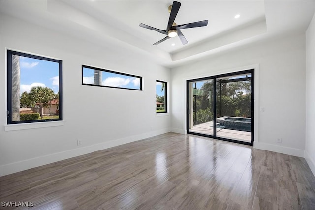 101 Beachcomber St, Marco Island, FL 34145 - spare room featuring a raised ceiling, wood finished floors, recessed lighting, and a ceiling fan