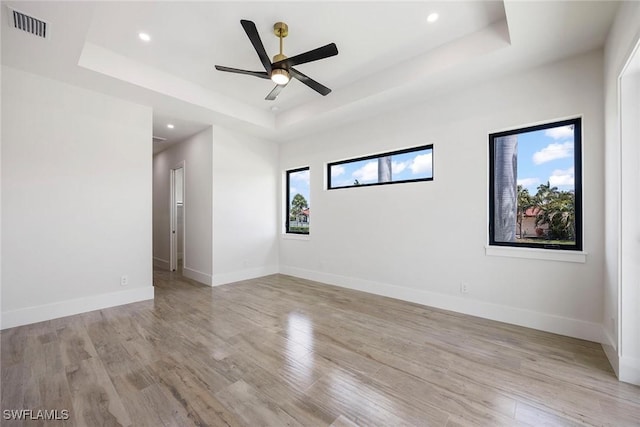 101 Beachcomber St, Marco Island, FL 34145 - spare room with a tray ceiling, light wood-type flooring, recessed lighting, and ceiling fan