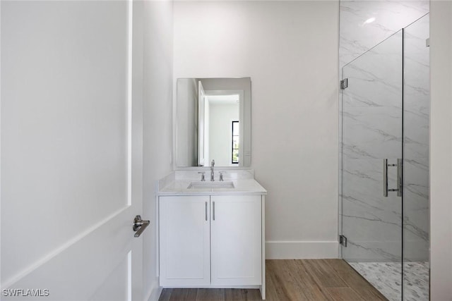 101 Beachcomber St, Marco Island, FL 34145 - bathroom with a marble finish shower, vanity, and wood finished floors