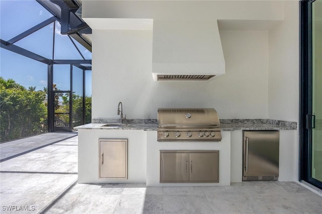 101 Beachcomber St, Marco Island, FL 34145 - view of patio with an outdoor kitchen and glass enclosure