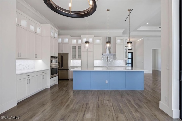 101 Beachcomber St, Marco Island, FL 34145 - kitchen with wall chimney exhaust hood, crown molding, dark wood-style floors, light countertops, and decorative backsplash