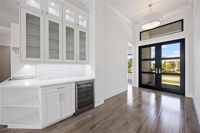 101 Beachcomber St, Marco Island, FL 34145 - bar with wine cooler, ornamental molding, french doors, wood finished floors, and decorative backsplash