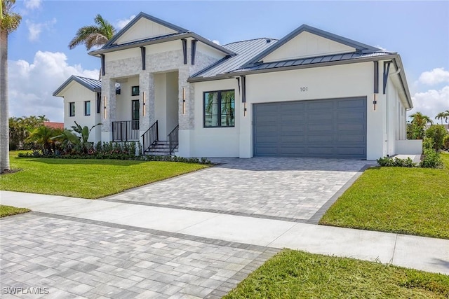 101 Beachcomber St, Marco Island, FL 34145 - view of front of home with a standing seam roof, a front lawn, an attached garage, decorative driveway, and a metal roof