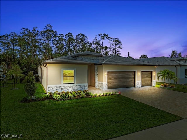 240 Allamanda Way, Naples, FL 34114 - prairie-style house with decorative driveway, stone siding, an attached garage, a lawn, and stucco siding