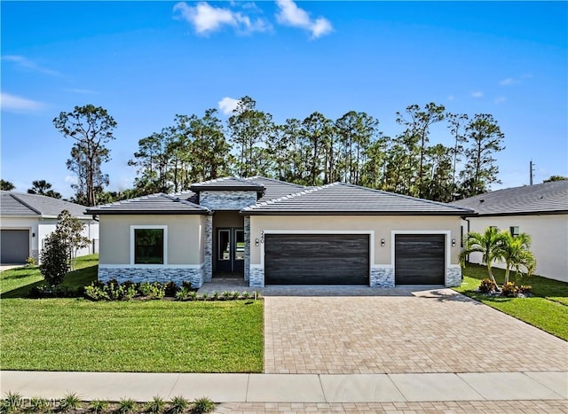 240 Allamanda Way, Naples, FL 34114 - prairie-style house with stone siding, an attached garage, decorative driveway, and stucco siding