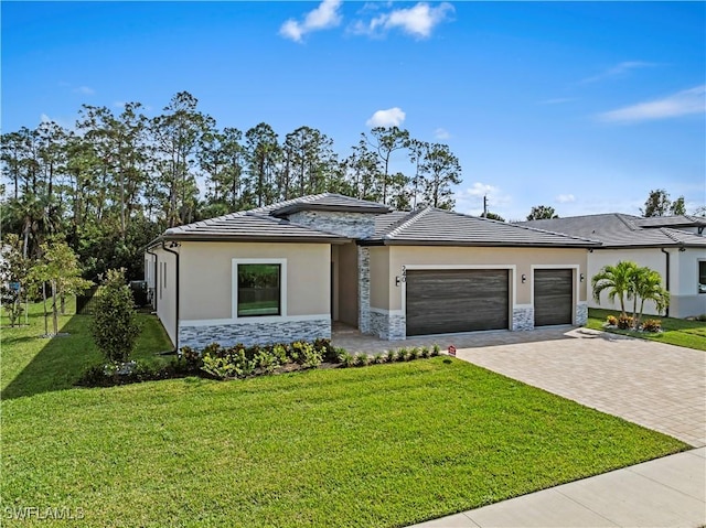 240 Allamanda Way, Naples, FL 34114 - prairie-style home with stone siding, decorative driveway, a garage, and a front lawn