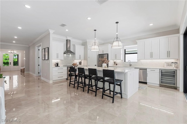 240 Allamanda Way, Naples, FL 34114 - kitchen with wall chimney exhaust hood, beverage cooler, stainless steel appliances, ornamental molding, and healthy amount of natural light