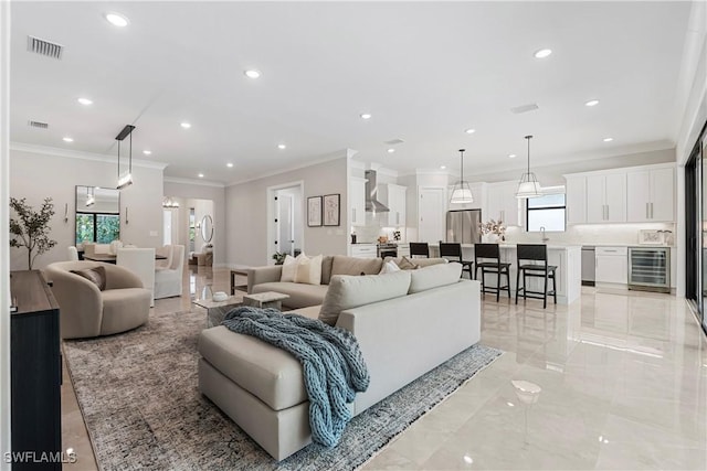 240 Allamanda Way, Naples, FL 34114 - living room featuring beverage cooler, ornamental molding, recessed lighting, and light marble finish floors
