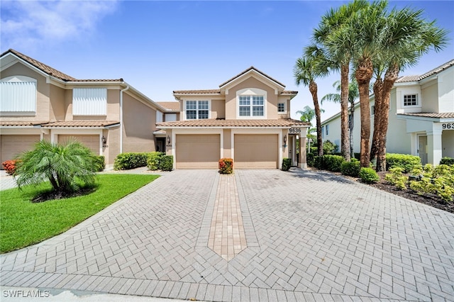 9636 Hemingway Ln Unit 4201, Fort Myers, FL 33913 - mediterranean / spanish home featuring an attached garage, decorative driveway, stucco siding, and a tile roof