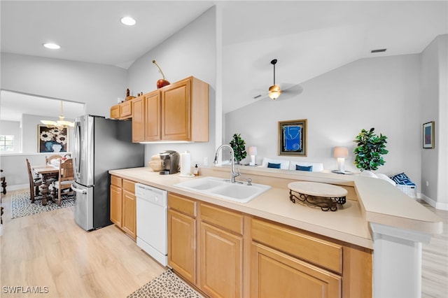 9636 Hemingway Ln Unit 4201, Fort Myers, FL 33913 - kitchen with white dishwasher, a peninsula, light wood-style floors, light brown cabinetry, and lofted ceiling