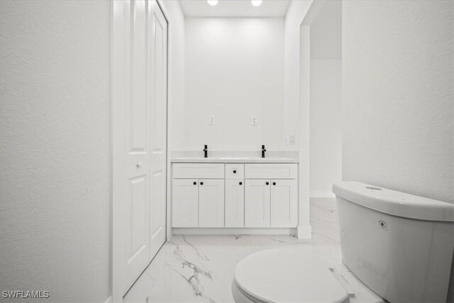 448 Majors Ave S, Lehigh Acres, FL 33974 - bathroom with marble finish flooring, double vanity, and a textured wall