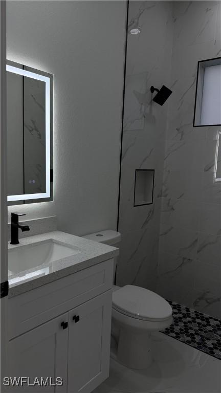 448 Majors Ave S, Lehigh Acres, FL 33974 - bathroom featuring vanity, marble finish flooring, and a marble finish shower