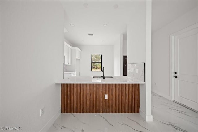 448 Majors Ave S, Lehigh Acres, FL 33974 - kitchen featuring light marble finish floors, a peninsula, light countertops, white cabinetry, and recessed lighting