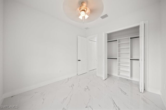448 Majors Ave S, Lehigh Acres, FL 33974 - unfurnished bedroom with marble finish floors, a closet, and ceiling fan