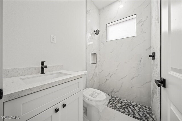 448 Majors Ave S, Lehigh Acres, FL 33974 - bathroom featuring a marble finish shower, vanity, and marble look tiles