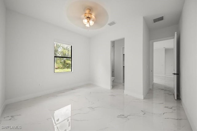448 Majors Ave S, Lehigh Acres, FL 33974 - unfurnished bedroom featuring light marble finish flooring, ensuite bathroom, and ceiling fan