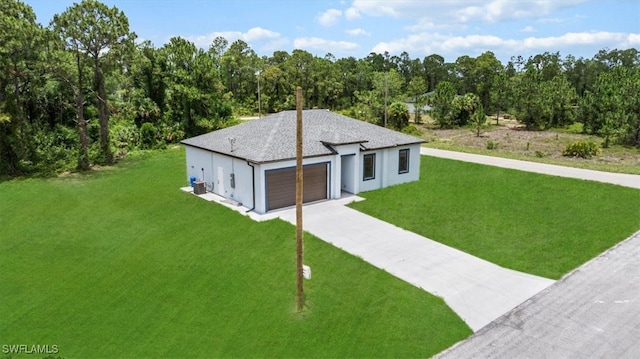448 Majors Ave S, Lehigh Acres, FL 33974 - contemporary house with a front yard, a garage, driveway, and stucco siding