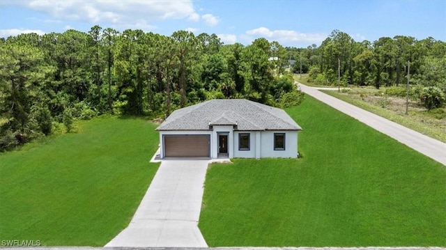 448 Majors Ave S, Lehigh Acres, FL 33974 - view of front of house featuring a front lawn, a forest view, driveway, and a garage