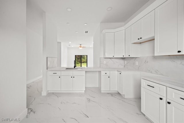 448 Majors Ave S, Lehigh Acres, FL 33974 - kitchen with light marble finish floors, recessed lighting, white cabinetry, tasteful backsplash, and a ceiling fan