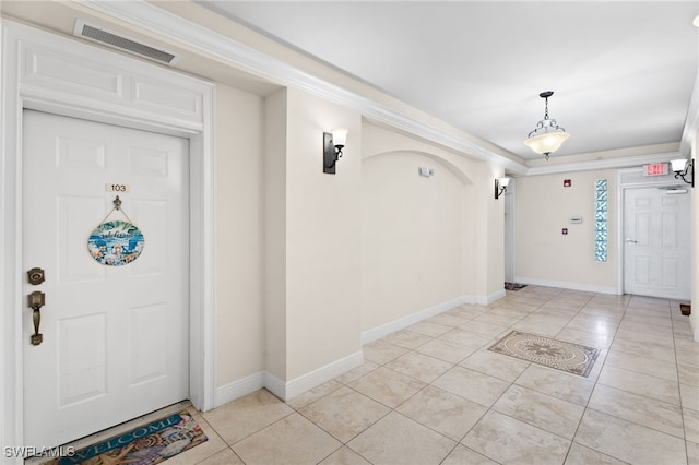 3939 Pomodoro Cir Unit 103, Cape Coral, FL 33909 - entryway with light tile patterned floors and ornamental molding