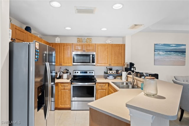 3939 Pomodoro Cir Unit 103, Cape Coral, FL 33909 - kitchen featuring stainless steel appliances, a peninsula, light tile patterned flooring, light countertops, and recessed lighting