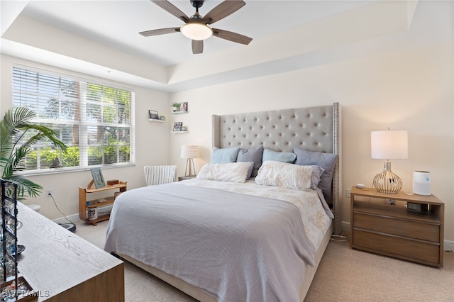 3939 Pomodoro Cir Unit 103, Cape Coral, FL 33909 - bedroom featuring light colored carpet, a tray ceiling, and a ceiling fan
