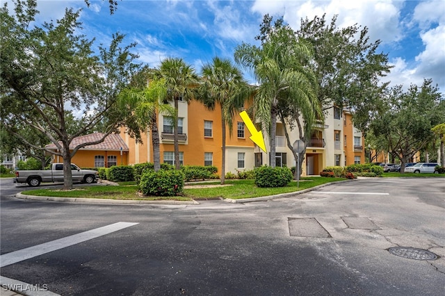 3939 Pomodoro Cir Unit 103, Cape Coral, FL 33909 - view of property featuring uncovered parking