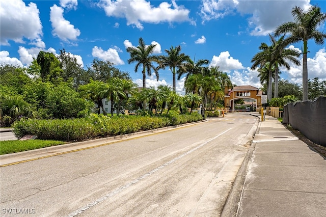 3939 Pomodoro Cir Unit 103, Cape Coral, FL 33909 - view of asphalt street featuring curbs, sidewalks, a gated entry, and a gate