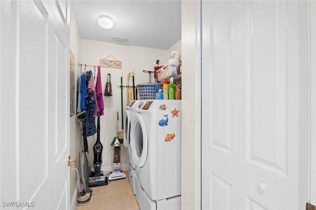 3939 Pomodoro Cir Unit 103, Cape Coral, FL 33909 - laundry area featuring light tile patterned floors and separate washer and dryer
