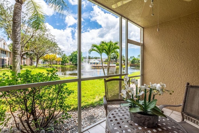 168 Pebble Shores Dr Unit 102, Naples, FL 34110 - sunroom featuring a water view and ceiling fan