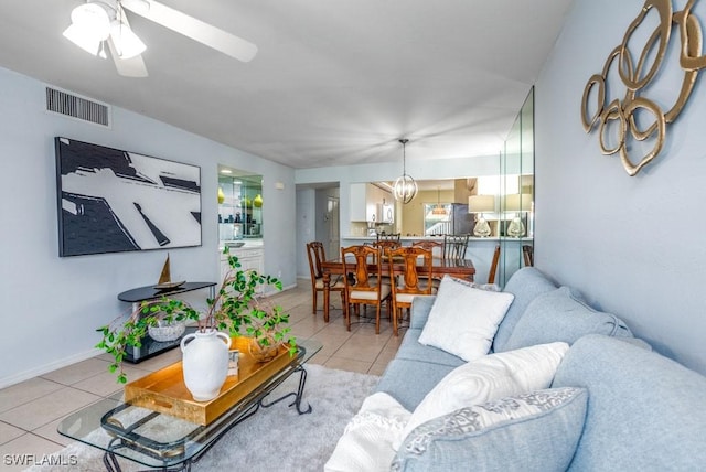 168 Pebble Shores Dr Unit 102, Naples, FL 34110 - living room with light tile patterned floors and a ceiling fan