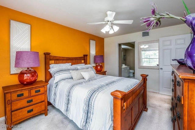 168 Pebble Shores Dr Unit 102, Naples, FL 34110 - bedroom with light colored carpet, ensuite bath, and a ceiling fan