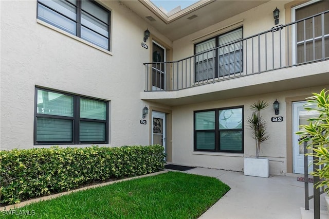 4001 SE 19th Pl Unit B1, Cape Coral, FL 33904 - property entrance with stucco siding and a balcony