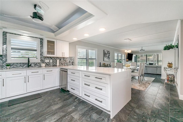 4001 SE 19th Pl Unit B1, Cape Coral, FL 33904 - kitchen featuring a peninsula, stainless steel dishwasher, light countertops, crown molding, and decorative backsplash