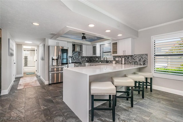 4001 SE 19th Pl Unit B1, Cape Coral, FL 33904 - kitchen featuring appliances with stainless steel finishes, a peninsula, crown molding, glass insert cabinets, and a breakfast bar area