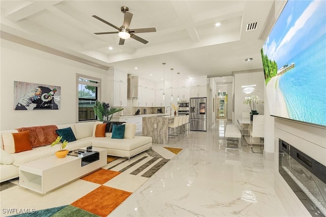 614 105th Ave N, Naples, FL 34108 - living room featuring ceiling fan, recessed lighting, light marble finish floors, coffered ceiling, and a tray ceiling