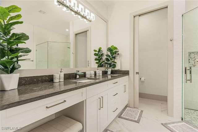 614 105th Ave N, Naples, FL 34108 - bathroom with marble look tile flooring, a stall shower, and double vanity