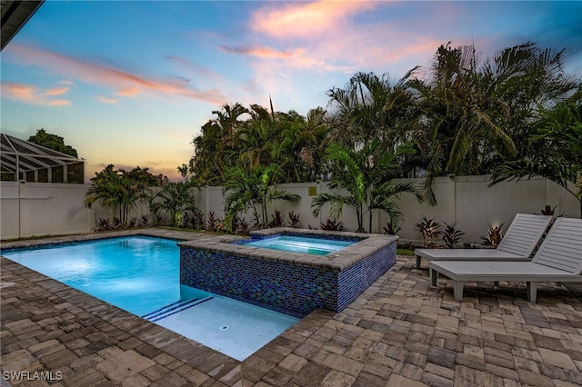 614 105th Ave N, Naples, FL 34108 - view of swimming pool featuring an in-ground hot tub, a patio, and a fenced backyard