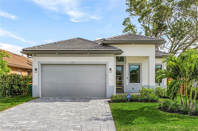 614 105th Ave N, Naples, FL 34108 - view of front of house featuring stucco siding, decorative driveway, an attached garage, and a front yard