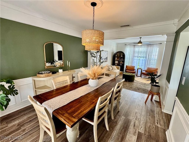 13356 Bristol Park Way, Fort Myers, FL 33913 - dining space with a decorative wall, crown molding, a chandelier, dark wood-type flooring, and wainscoting