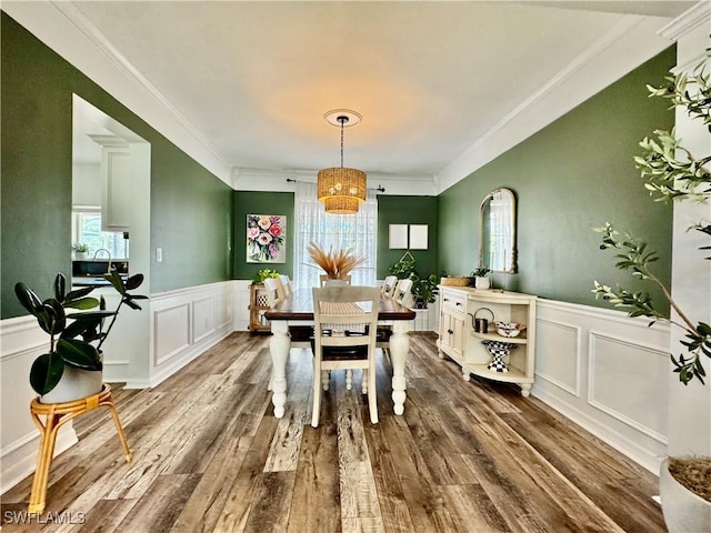 13356 Bristol Park Way, Fort Myers, FL 33913 - dining space featuring a decorative wall, wainscoting, ornamental molding, dark wood-style flooring, and a chandelier