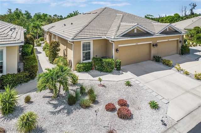 10406 Santiva Way, Fort Myers, FL 33908 - view of front of property with stucco siding, concrete driveway, an attached garage, and a tiled roof