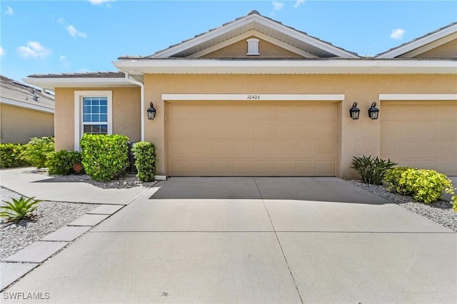 10406 Santiva Way, Fort Myers, FL 33908 - view of front facade with stucco siding, concrete driveway, and an attached garage