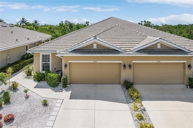 10406 Santiva Way, Fort Myers, FL 33908 - view of front of home featuring concrete driveway, a garage, and stucco siding