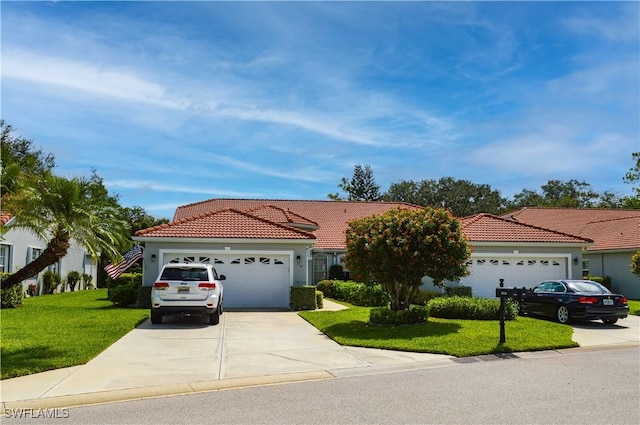 314 Melrose Pl Unit 33, Naples, FL 34104 - mediterranean / spanish-style house featuring a garage, concrete driveway, a front lawn, a tile roof, and stucco siding