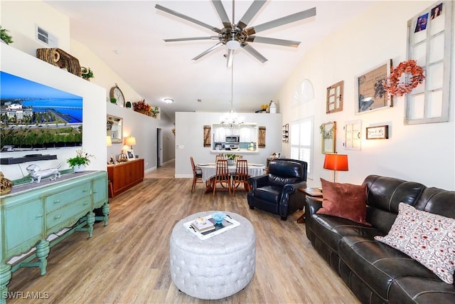 314 Melrose Pl Unit 33, Naples, FL 34104 - living area with lofted ceiling, a chandelier, wood finished floors, and a ceiling fan