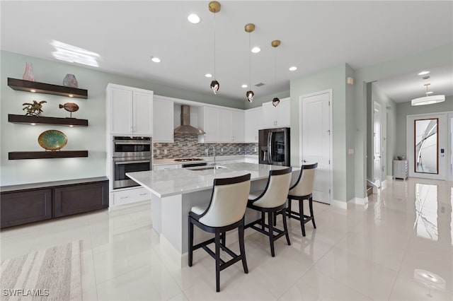 20368 Estero Crossing Blvd, Estero, FL 33928 - kitchen featuring appliances with stainless steel finishes, wall chimney exhaust hood, backsplash, light tile patterned floors, and white cabinets