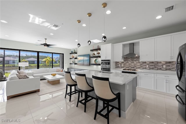 20368 Estero Crossing Blvd, Estero, FL 33928 - kitchen with wall chimney exhaust hood, freestanding refrigerator, decorative backsplash, a ceiling fan, and pendant lighting