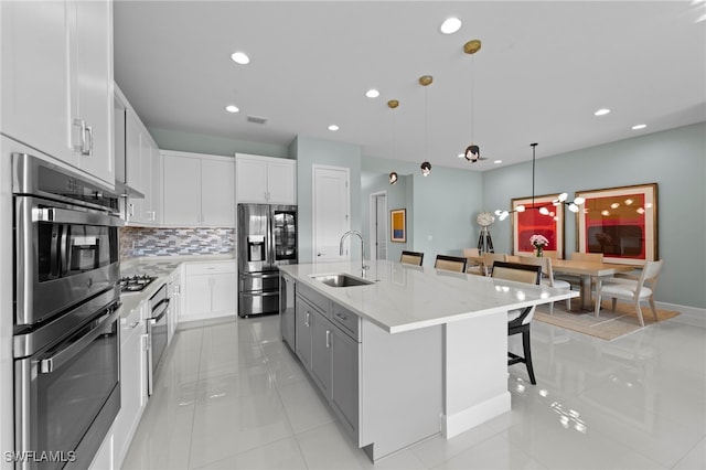 20368 Estero Crossing Blvd, Estero, FL 33928 - kitchen featuring appliances with stainless steel finishes, a breakfast bar area, tasteful backsplash, recessed lighting, and white cabinetry