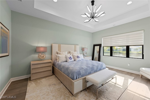20368 Estero Crossing Blvd, Estero, FL 33928 - bedroom with a chandelier, a raised ceiling, light wood-style floors, and recessed lighting